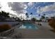 Inviting community pool with lounge chairs, surrounded by mature landscaping and palm trees at 4206 N 38Th St # 3, Phoenix, AZ 85018