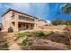 Large backyard showcasing a two-story home with a balcony and plenty of space for landscaping at 45105 W Horse Mesa Rd, Maricopa, AZ 85139