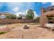 Spacious backyard showcasing a brick fence, a fire pit, and outdoor living potential at 45105 W Horse Mesa Rd, Maricopa, AZ 85139