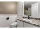 This bathroom features a sink with granite countertops, a toilet, and a shower at 45105 W Horse Mesa Rd, Maricopa, AZ 85139