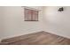 This bedroom features wood floors and a window with blinds at 45105 W Horse Mesa Rd, Maricopa, AZ 85139