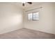 This bedroom has neutral carpet and a window with blinds at 45105 W Horse Mesa Rd, Maricopa, AZ 85139