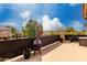 Cozy deck area featuring an outdoor fireplace and providing a relaxing outdoor living space at 45105 W Horse Mesa Rd, Maricopa, AZ 85139