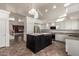 Open kitchen with granite countertops, black island, stainless steel appliances, and a view into the living area at 45105 W Horse Mesa Rd, Maricopa, AZ 85139