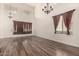 Bright living room featuring wood floors, high ceilings, and large windows at 45105 W Horse Mesa Rd, Maricopa, AZ 85139