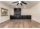 Cozy living room with a fireplace, custom millwork, and a ceiling fan at 45105 W Horse Mesa Rd, Maricopa, AZ 85139