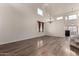 Spacious living room featuring wood floors, high ceilings, a chandelier, and large windows at 45105 W Horse Mesa Rd, Maricopa, AZ 85139