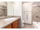 Bathroom with tiled shower and single sink vanity offers functionality and neutral tones at 4701 E Voltaire Ave, Phoenix, AZ 85032