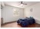 Bedroom with hardwood floors and a ceiling fan provides a comfortable living space at 4701 E Voltaire Ave, Phoenix, AZ 85032