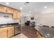 Cozy kitchen seamlessly flowing into a living area, complemented by stainless steel appliances at 4701 E Voltaire Ave, Phoenix, AZ 85032