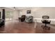 Inviting living room with hardwood flooring, a ceiling fan, and sliding door access to the backyard at 4701 E Voltaire Ave, Phoenix, AZ 85032