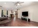 Inviting living room with dark wood floors and a ceiling fan provides a comfortable living space at 4701 E Voltaire Ave, Phoenix, AZ 85032