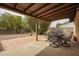 Covered patio with an outdoor dining area provides a relaxing outdoor space for entertaining at 4701 E Voltaire Ave, Phoenix, AZ 85032