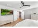 Bedroom with a plush white bedspread, a flat screen TV, and a view of the entry to the staircase at 4705 E Betty Elyse Ln, Phoenix, AZ 85032