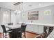 Dining room boasts a marble table, modern light fixture, and built-in cabinets with wine storage at 4705 E Betty Elyse Ln, Phoenix, AZ 85032