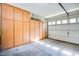 Spacious garage with built-in storage cabinets along one wall offering organization and ample space at 4705 E Betty Elyse Ln, Phoenix, AZ 85032