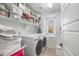 This laundry room features a washer and dryer as well as shelving for storage at 4705 E Betty Elyse Ln, Phoenix, AZ 85032