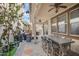 Inviting covered patio featuring a dining table, ceiling fans, and comfortable seating area with a modern fire pit at 4705 E Betty Elyse Ln, Phoenix, AZ 85032