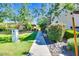 Picturesque walkway bordered by lush greenery, manicured shrubs, and decorative rocks at 4705 E Betty Elyse Ln, Phoenix, AZ 85032