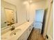 Bathroom showcasing dual sinks, elegant mirrors, and tiled flooring at 47248 W Cansados Rd, Maricopa, AZ 85139