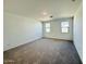 Large, carpeted bedroom featuring multiple windows, providing great natural light at 47248 W Cansados Rd, Maricopa, AZ 85139