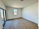 Bright room with tiled flooring, a sliding glass door, and a window at 47248 W Cansados Rd, Maricopa, AZ 85139
