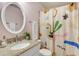 Bathroom featuring a granite countertop, round mirror, and colorful shower curtain at 4901 E Kelton Ln # 1227, Scottsdale, AZ 85254