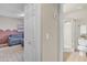 A cozy bedroom provides a glimpse into an adjacent bathroom with a glass-enclosed shower and modern fixtures at 4901 E Kelton Ln # 1227, Scottsdale, AZ 85254