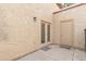 Back patio with a stucco wall, double doors and an entry door with welcome mats at 4901 E Kelton Ln # 1227, Scottsdale, AZ 85254