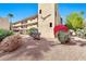 Apartment building with balconies, desert landscaping and colorful bougainvillea at 4950 N Miller Rd # 240, Scottsdale, AZ 85251