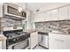 Modern kitchen featuring stainless-steel appliances and stylish tile backsplash at 4950 N Miller Rd # 240, Scottsdale, AZ 85251