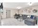 Cozy living room featuring a large gray sectional sofa, tile floors and stylish decor at 4950 N Miller Rd # 240, Scottsdale, AZ 85251