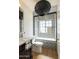 Modern bathroom with a black and white tiled shower, dark vanity, and contemporary fixtures at 5137 E Flower St, Phoenix, AZ 85018