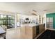 Open-concept kitchen with an island seamlessly transitions into the living room, creating a spacious and inviting area at 5137 E Flower St, Phoenix, AZ 85018