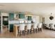 Open-concept kitchen with an island and bar seating, flowing seamlessly into a dining area at 5137 E Flower St, Phoenix, AZ 85018