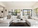 Bright living room with a comfortable white sectional sofa, modern rug, and views of the outdoor scenery at 5137 E Flower St, Phoenix, AZ 85018