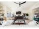 Bright living room featuring modern decor, sleek ceiling fan, and a stylish entertainment center at 5137 E Flower St, Phoenix, AZ 85018