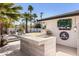 Outdoor kitchen with a built-in grill, bar area, and charming decor, ideal for entertaining at 5137 E Flower St, Phoenix, AZ 85018