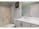 Bathroom with white vanity, tub, and shower with matching hardware and blue accent wall at 5230 E Brown Rd # 117, Mesa, AZ 85205