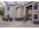 Updated condo exterior boasting neutral tones, stone accents, tidy landscaping, and a private entrance at 5230 E Brown Rd # 117, Mesa, AZ 85205