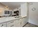 Bright kitchen features updated stainless steel sink with white cabinets and flows into the living area at 5230 E Brown Rd # 117, Mesa, AZ 85205