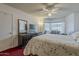 Bright main bedroom featuring a ceiling fan, desk area, and large windows for natural light at 5230 E Brown Rd # C117, Mesa, AZ 85205