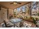 Relaxing covered patio with a ceiling fan, outdoor seating, lush greenery, and a pergola view at 5230 E Brown Rd # C117, Mesa, AZ 85205