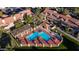 Aerial view of a community pool with plenty of seating and a pergola for shade at 5230 E Brown Rd # C117, Mesa, AZ 85205