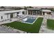 Stunning backyard featuring a modern pool, lush grass, lounge area, and desert landscaping at 5287 N Invergordon Rd, Paradise Valley, AZ 85253