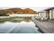 Stunning pool reflects the desert landscape, complemented by stylish lounge chairs and umbrellas at 5287 N Invergordon Rd, Paradise Valley, AZ 85253