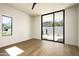 Bright bedroom with hardwood floors and a sliding glass door to the backyard and desert landscape at 5287 N Invergordon Rd, Paradise Valley, AZ 85253