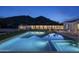 Night view of a modern pool reflecting the night sky and desert landscape, offering a tranquil setting at 5287 N Invergordon Rd, Paradise Valley, AZ 85253