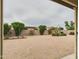 Backyard view featuring desert landscaping, a covered patio, and a brick fence at 6050 S Crosscreek Ct, Chandler, AZ 85249