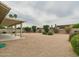 Large backyard featuring desert landscaping, a covered patio, and a brick fence at 6050 S Crosscreek Ct, Chandler, AZ 85249